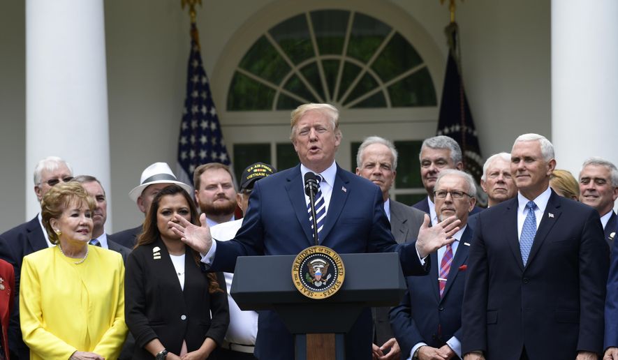 President Donald Trump participates in a bill signing ceremony for the "VA Mission Act" in the Rose Garden of the White House, Wednesday, June 6, 2018, in Washington. The legislation authorizes new health care programs for veterans, but the bill does not reserve federal money to pay for those programs. (AP Photo/Susan Walsh)