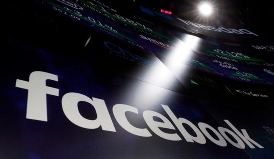FILE- In this March 29, 2018, file photo the logo for Facebook appears on screens at the Nasdaq MarketSite in New York&#39;s Times Square. Facebook says a software bug made some private posts public for as many as 14 million users for several days in May. (AP Photo/Richard Drew, File)