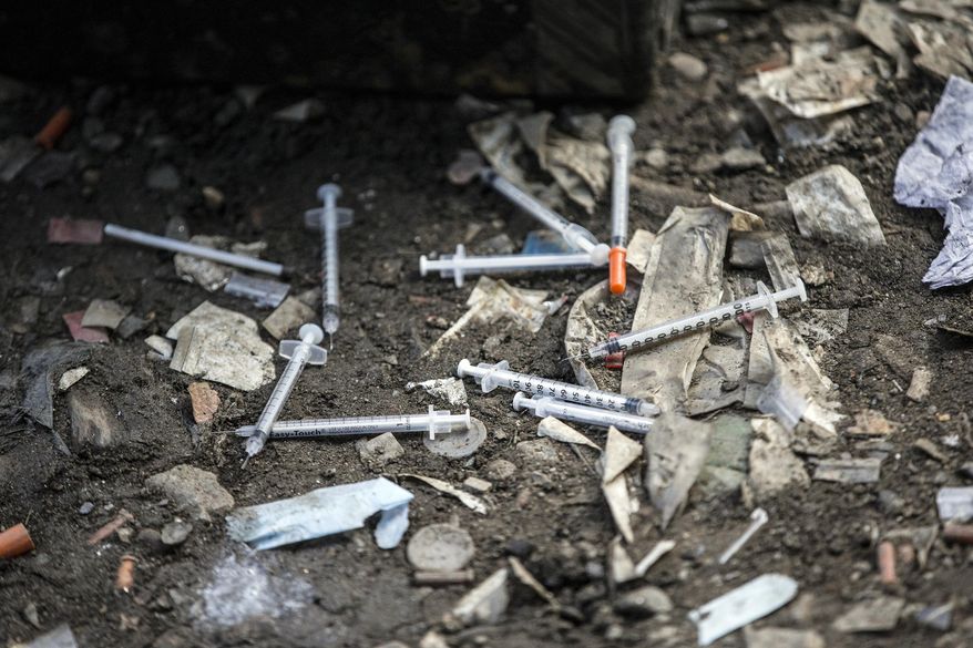 This Feb. 2, 2017 file photo, shows used needles littering the ground along train tracks in Philadelphia's largest open air drug market in the Kensington section of the city. (Michael Bryant/The Philadelphia Inquirer via AP) **FILE**