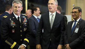 NATO Secretary General Jens Stoltenberg, center, speaks with the top commander of U.S. forces in Afghanistan General John Nicholson, left, and Afghanistan&#39;s Defense Minister Tariq Shah Bahrami, right, during a round table meeting of the North Atlantic Council with Resolute Support Operational Partner Nations at NATO headquarters in Brussels, Friday, June 8, 2018. (AP Photo/Virginia Mayo)