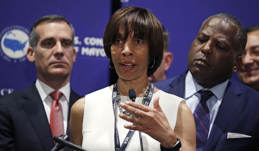 Baltimore Mayor Catherine Pugh addresses a gathering during the annual meeting of the U.S. Conference of Mayors in Boston, Friday, June 8, 2018. More than 250 city executives gathered to discuss their concerns including infrastructure, school safety, immigration and the economic future of cities. With Pugh are Los Angeles Mayor Eric Garcetti, left, and Columbia, S.C., Mayor Steve Benjamin. (AP Photo/Charles Krupa)