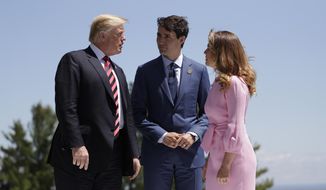 President Donald Trump is greeted by Canadian Prime Minister Justin Trudeau and his wife Sophie Gregoire Trudeau, during the G7 Summit, Friday, June 8, 2018, in Charlevoix, Canada. (AP Photo/Evan Vucci)