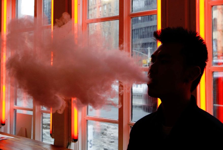 Vape enthusiasts may consider giving up their habit if the Chinese-produced devices are hit by Trump administration tariffs. (Associated Press/File)