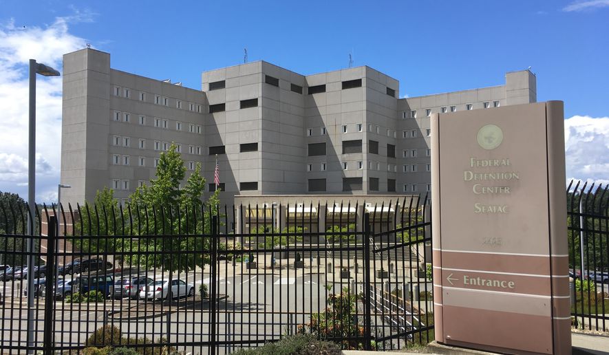 This Friday, June 8, 2018 photo shows the Federal Detention Center in SeaTac, Wash. The Northwest Immigrant Rights Project reported that as many as 120 asylum seekers had been transferred to this facility. Washington state's governor says six children were brought to a Seattle foster care facility after federal immigration authorities separated them from their families at the border. (AP Photo/Sally Ho)
