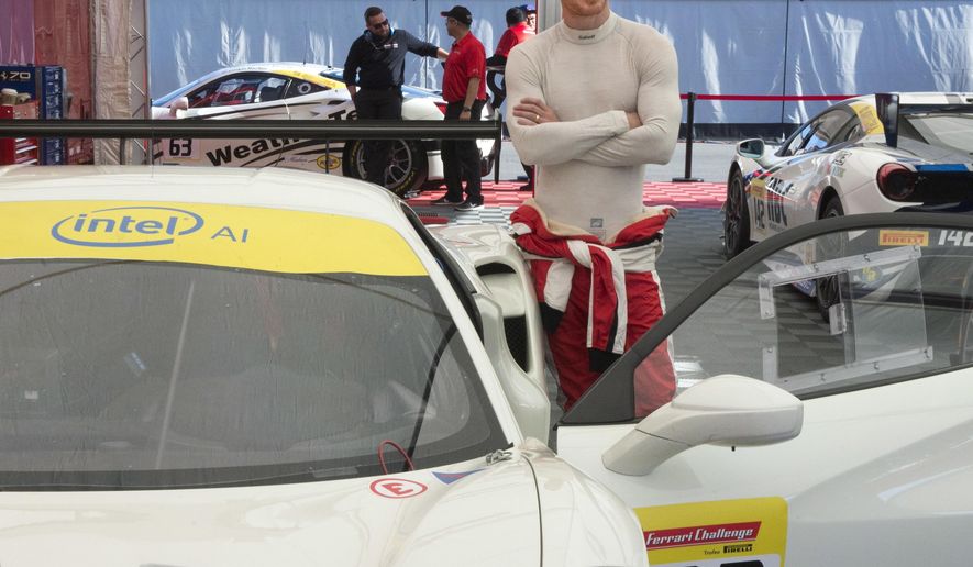 Actor Michael Fassbender gets ready for the Ferarri Challenge practice at the Formula One Canadian Grand Prix auto race in Montreal, Friday, June 8, 2018. (Ryan Remiorz/The Canadian Press via AP)