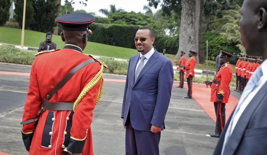 Ethiopia's new Prime Minister Abiy Ahmed, 42, who was installed in April, inspects the honor guard as he arrives to meet for bilateral talks with Uganda's President Yoweri Museveni at State House in Entebbe, Uganda Friday, June 8, 2018. Sweeping changes that seemed unthinkable just weeks ago have been announced almost daily since Ahmed, Africa's youngest head of government, took office and vowed to bring months of deadly protests to an end. (AP Photo/Ronald Kabuubi)