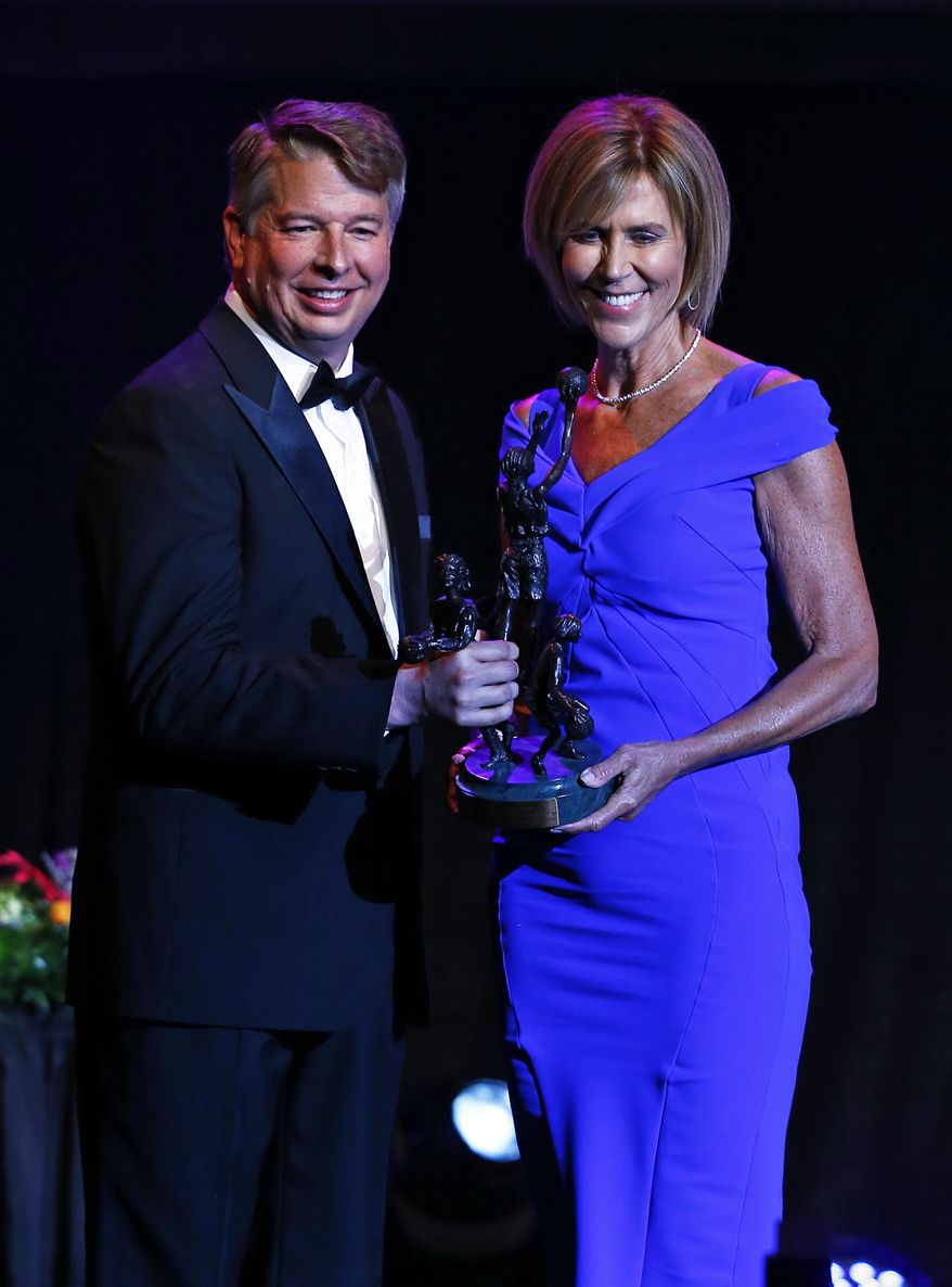 Connecticut assistant coach Chris Dailey, right, accepts the award from David Golden during induction ceremonies at he Women's Basketball Hall of Fame Saturday, June 9, 2018, in Knoxville, Tenn. (AP Photo/Wade Payne)