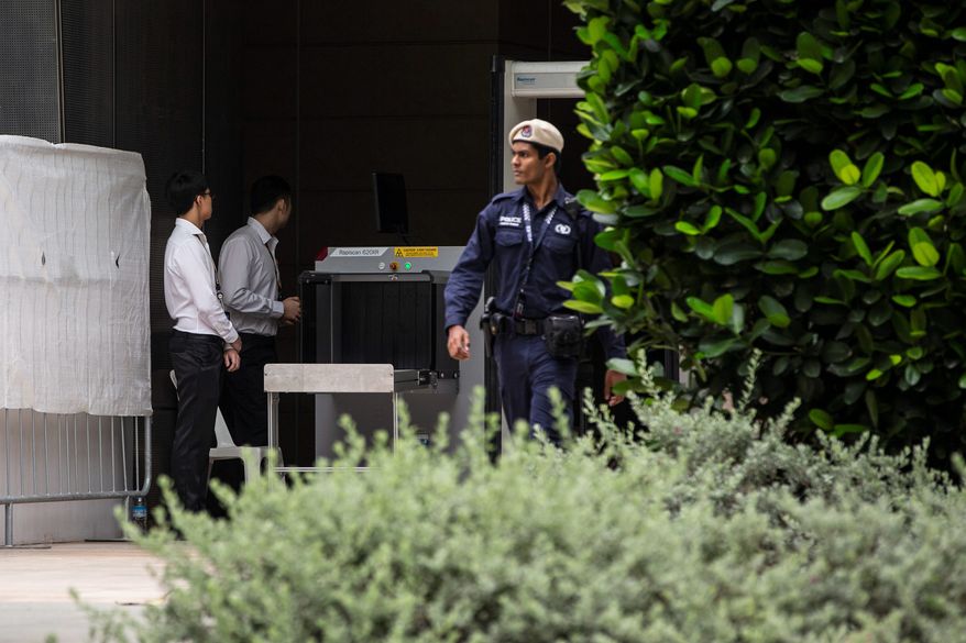 A police officer walks out of a security screening booth at the St. Regis Hotel in Singapore on Sunday ahead of Tuesday's summit between President Trump and North Korean leader Kim Jong-un. (Associated Press)