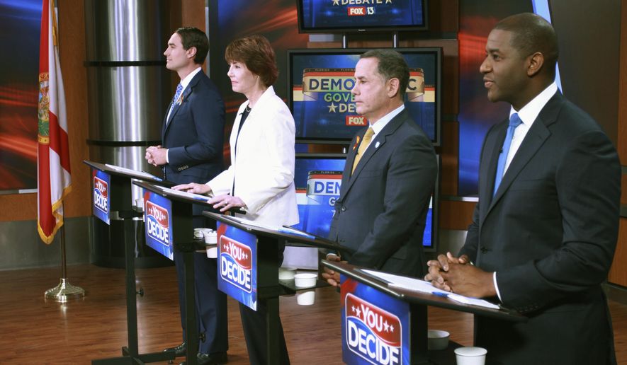 FILE - In this April 18, 2018, file photo, Tallahassee Mayor Andrew Gillum, Miami Beach Mayor Philip Levine, former U.S. Rep. Gwen Graham, and businessman Chris King listen to the moderator during the first gubernatorial debate in the Democratic primary in Tampa, Fla. For the first half of their second debate, four contenders for Florida's Democratic gubernatorial nomination were about as civil as can be Saturday night, June 9, 2018, and hardly differed on issues of restoring voting rights to former convicts and opposition to for-profit charter schools. But mentions of Syrian refugees and a campaign contribution to U.S. Sen. Marco Rubio heated up the debate inside a Largo, Fla., high school. (WTVT Fox 13 via AP, Pool, File)