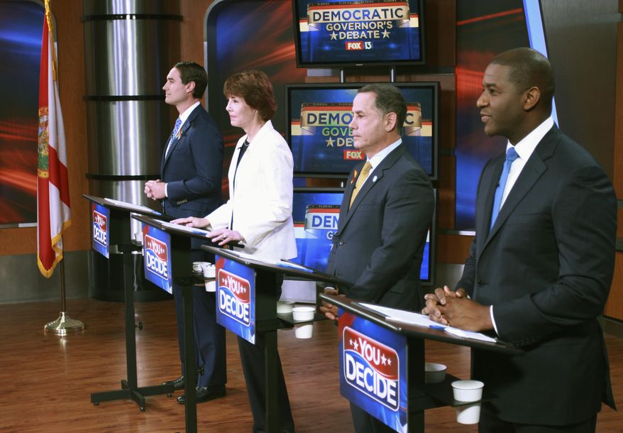 FILE - In this April 18, 2018, file photo, Tallahassee Mayor Andrew Gillum, Miami Beach Mayor Philip Levine, former U.S. Rep. Gwen Graham, and businessman Chris King listen to the moderator during the first gubernatorial debate in the Democratic primary in Tampa, Fla. For the first half of their second debate, four contenders for Florida's Democratic gubernatorial nomination were about as civil as can be Saturday night, June 9, 2018, and hardly differed on issues of restoring voting rights to former convicts and opposition to for-profit charter schools. But mentions of Syrian refugees and a campaign contribution to U.S. Sen. Marco Rubio heated up the debate inside a Largo, Fla., high school. (WTVT Fox 13 via AP, Pool, File)