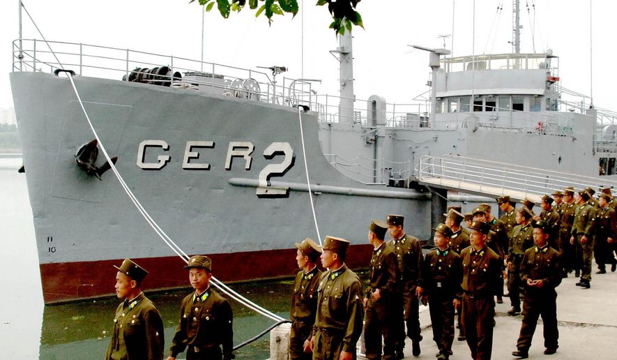 In this June 22, 2006, file photo released by the North Korean government, North Korean soldiers watch USS Pueblo, which was seized by North Korean navy off the Korean coast near Taedonggang river in Pyongyang, North Korea. In January 1968, North Korean navy boats attacked and captured the USS Pueblo off the North’s east coast. (Korean Central News Agency/Korea News Service via AP, File)