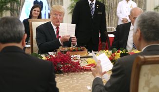 In this photo released by the Ministry of Communications and Information of Singapore, U.S. President Donald Trump gets an early birthday celebration during lunch with Singapore&#39;s Prime Minister Lee Hsien Loong in Singapore, Monday, June 11, 2018. Trump turns 72 on Thursday. (Ministry of Communications and Information Singapore via AP)