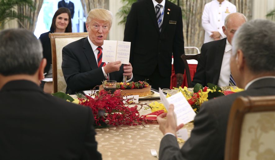 In this photo released by the Ministry of Communications and Information of Singapore, U.S. President Donald Trump gets an early birthday celebration during lunch with Singapore&#x27;s Prime Minister Lee Hsien Loong in Singapore, Monday, June 11, 2018. Trump turns 72 on Thursday. (Ministry of Communications and Information Singapore via AP)