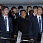 North Korean leader Kim Jong-un, center, walks in Marina Bay, Singapore Monday, June 11, 2018, ahead of the summit with U.S. President Donald Trump. (AP Photo/Gemunu Amarasinghe)
