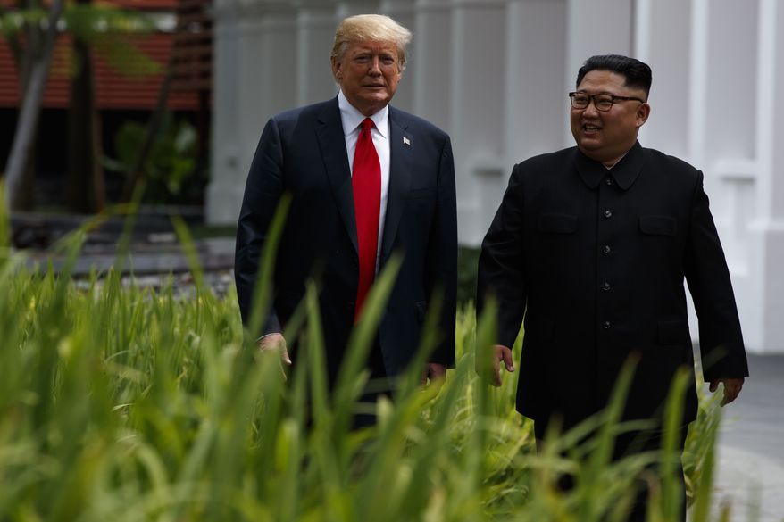 President Donald Trump walks with North Korean leader Kim Jong Un on Sentosa Island, Tuesday, June 12, 2018, in Singapore. (AP Photo/Evan Vucci)