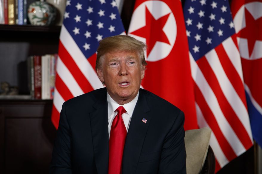 President Donald Trump listens during a meeting with North Korean leader Kim Jong Un on Sentosa Island, Tuesday, June 12, 2018, in Singapore. (AP Photo/Evan Vucci)