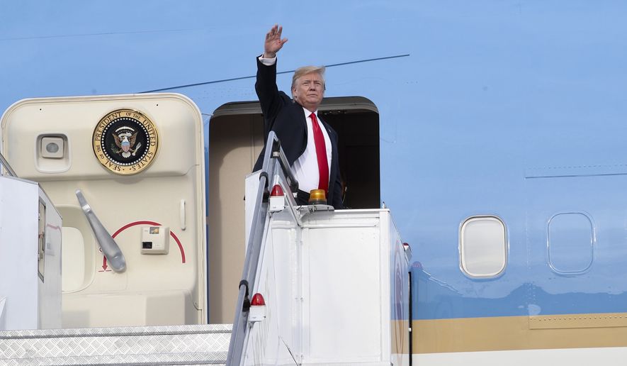 In this photo released by the Ministry of Communications and Information, Singapore, U.S. President Donald Trump waves as he boards Air Force One following a summit with North Korean leader Kim Jong-un Tuesday, June 12, 2018, in Singapore. (Ministry of Communications and Information, Singapore via AP)
