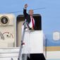 In this photo released by the Ministry of Communications and Information, Singapore, U.S. President Donald Trump waves as he boards Air Force One following a summit with North Korean leader Kim Jong-un Tuesday, June 12, 2018, in Singapore. (Ministry of Communications and Information, Singapore via AP)