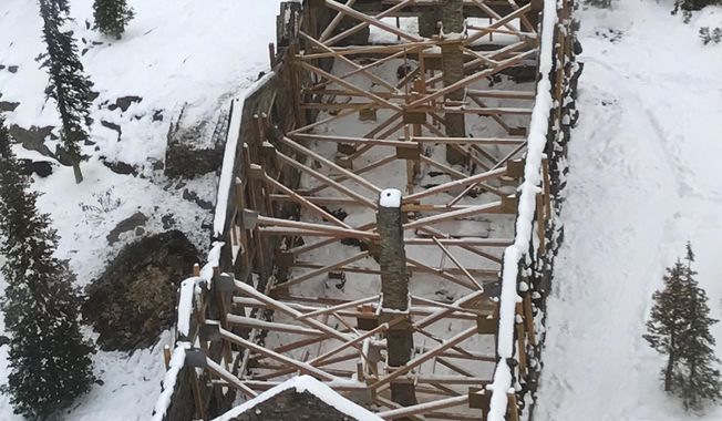 This undated photo provided by the U.S. National Park Service shows the Sperry Chalet in Glacier National Park in northern Montana, after it was destroyed in a wildfire in 2017. The park service has awarded a $4 million construction contract to a Montana company to begin rebuilding the backcountry chalet. Temporary support timbers shore up the stone walls. Helena-based Dick Anderson Construction is expected to begin work on the Sperry Chalet dormitory this summer. (U.S. National Park Service via AP)