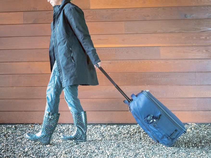 This June 2018 photo provided by VLES shows the company's GO-bag being wheeled. The bag is a best-in-class fully-stocked emergency bag that has things you could need in case of an emergency and has plenty of room for the personal items you'll need. (VLES via AP)