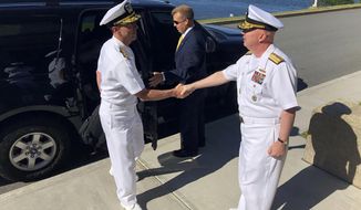 Adm. John Richardson, left, chief of naval operations, greets Rear Adm. Jeffrey Harley, president of the U.S. Naval War College, Tuesday, June 12, 2018, in Newport, R.I. U.S. Navy leaders are in Rhode Island to strategize with scholars about how technology and innovation will affect the nation&#39;s security. (AP Photo/Jennifer McDermott)