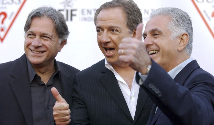FILE - In this May 9, 2002 file photo, Guess Inc. founders and brothers, from left, Armand, Paul and Maurice Marciano arrive at the company's 20th anniversary party in Los Angeles. Guess Inc. says its co-founder Paul Marciano is stepping down after a company-commissioned investigation of allegations of sexual harassment and assault. The company announced in a filing Tuesday, June 12, 2018, with the Securities and Exchange Commission that Marciano is resigning immediately as executive chairman of the Guess board, and his brother and co-founder Maurice Marciano will take over. (AP Photo/Chris Pizzello, File)