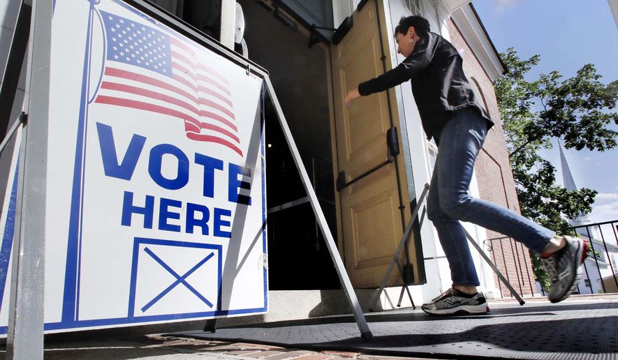 A resident arrives to cast her vote at a polling station at the Kennebunk Town Hall in Kennebunk, Maine, Tuesday, June 12, 2018. (AP Photo/Charles Krupa)