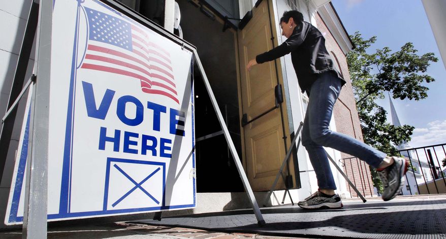A resident arrives to cast her vote at a polling station at the Kennebunk Town Hall in Kennebunk, Maine, Tuesday, June 12, 2018. (AP Photo/Charles Krupa)