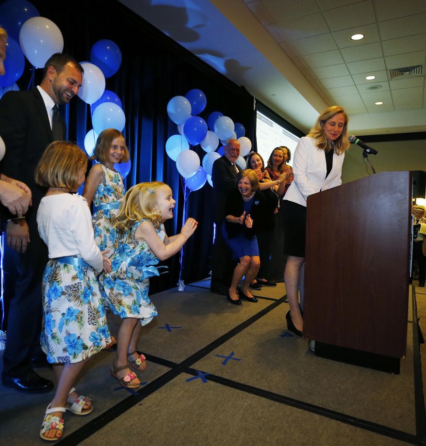 Daughter Catherine jumps for joy as Abigail Spanberger, Virginia's 7th District Democratic primary candidate, accepts the nomination on Tuesday June 12, 2018 at The Westin in Richmond, Va..At left is husband, Adam. She will face incumbent Dave Brat in November. (Joe Mahoney/Richmond Times-Dispatch via AP)
