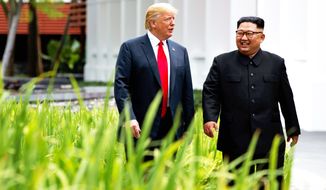 President Donald Trump walks with North Korean leader Kim Jong Un on Sentosa Island, Tuesday, June 12, 2018, in Singapore. (AP Photo/Evan Vucci)