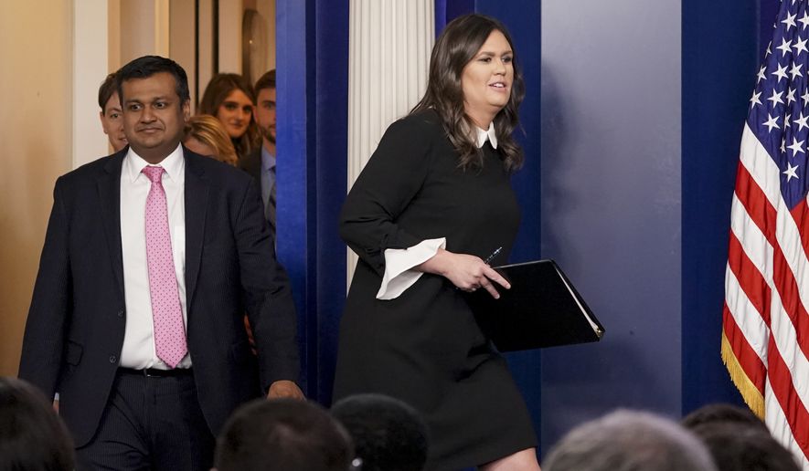 White House press secretary Sarah Huckabee Sanders, right, accompanied by White House principal deputy press secretary Raj Shah, left, arrives to speak to the media during the daily press briefing at the White House, Tuesday, March 27, 2018, in Washington. Sanders discussed the removal of Russian diplomats, the opiate crisis, and other topics. (AP Photo/Andrew Harnik)
