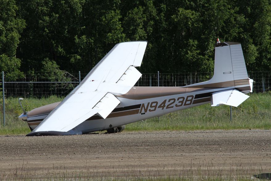 A damaged aircraft is seen at Lake Hood Seaplane Base on Wednesday, June 13, 2018, in Anchorage, Alaska. Alaska State Troopers say two planes were involved in a mid-air collision Wednesday north of Anchorage, with the wreckage of one plane spotted in a river and the other landing at the seaplane base. (AP Photo/Mark Thiessen)