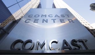 FILE - This March 29, 2017, file photo shows a sign outside the Comcast Center in Philadelphia. Comcast made a $65 billion bid Wednesday for Fox&#39;s entertainment businesses, setting up a battle with Disney to become the next mega-media company. (AP Photo/Matt Rourke, File)