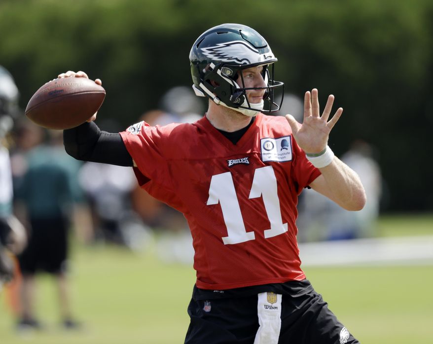 FILE - In this Thursday, June 7, 2018, file photo, Philadelphia Eagles' Carson Wentz runs a drill during an organized team activity at the NFL football team's practice facility, in Philadelphia. Wentz was having an MVP season before a torn ACL forced him to the sideline where he watched Nick Foles lead the Philadelphia Eagles to their first Super Bowl victory. His friendship with Super Bowl MVP Nick Foles appears without the strain seen in other famed NFL tandems. (AP Photo/Matt Slocum, File)