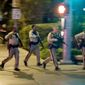 FILE - In this Oct. 1, 2017, file photo, police run toward the scene of a shooting near the Mandalay Bay resort and casino on the Las Vegas Strip in Las Vegas. Police planned to release body-worn camera video from officers who responded to the deadliest shooting in the nation&#x27;s modern history last year on the Las Vegas Strip. The material released Wednesday, June 13, 2018, represents the sixth batch of Oct. 1 shooting material released since May 30 without comment by Clark County Sheriff Joe Lombardo or his department. Fifty-eight people died and hundreds were injured before authorities say the gunman, Stephen Paddock, killed himself before police reached him. (AP Photo/John Locher, File)