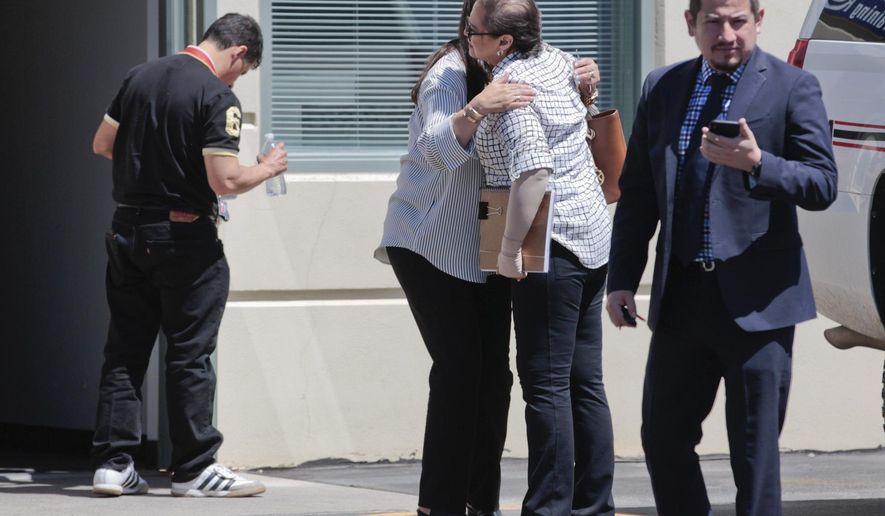 Members of the Salgado family hug after exiting the North Annex building at the Utah County Sheriff's Office on Wednesday, June 13, 2018, in Spanish Fork, Utah. The family of a Mexican woman found dead in Provo are in Utah to meet with and pressure investigators to solve the case. The 26-year-old Elizabeth Elena Laguna Salgado, of Chiapas, Mexico, who was missing since April 16, 2015, was found in Hobble Creek Canyon. (Evan Cobb/The Daily Herald via AP)