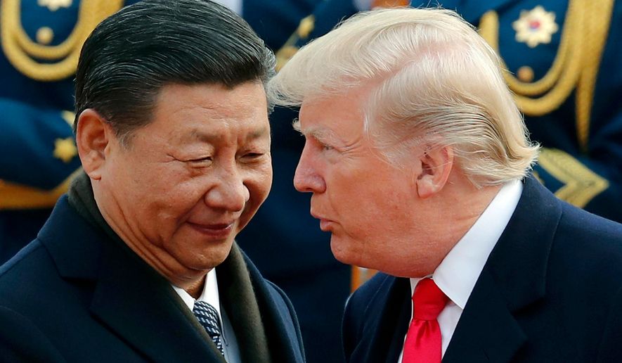 In this Nov. 9, 2017, photo, U.S. President Donald Trump, right, chats with Chinese President Xi Jinping during a welcome ceremony at the Great Hall of the People in Beijing. The Trump administration has once again declined to brand China a currency manipulator, but it did target that country and five others for special monitoring for what the administration says are practices that are worsening America&#x27;s trade deficit. (AP Photo/Andy Wong, File)