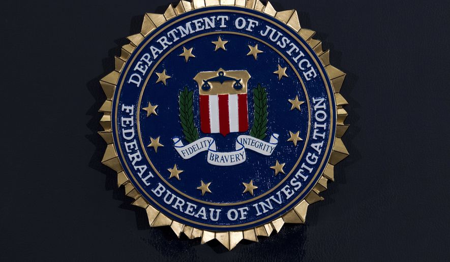 The FBI seal is seen before FBI Director Christopher Wray news conference on the inspector general's report at FBI headquarters on Thursday, June 14, 2018, in Washington. (AP Photo/Jose Luis Magana)