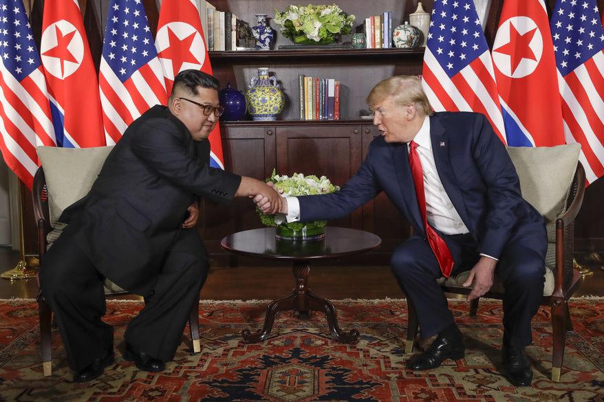 In this Tuesday, June 12, 2018, file photo, North Korea leader Kim Jong-un, left, and U.S. President Donald Trump shake hands during their first meeting at the Capella resort on Sentosa Island in Singapore. (AP Photo/Evan Vucci, File)