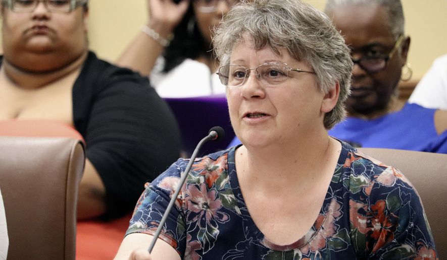 Debbie Holt, of Centerton, Ark., tells the prisons subcommittee of the Arkansas Legislative Council in Little Rock on Thursday, June 14, 2018, that two incarcerated sons have received poor medical care behind bars. After hearing similar complaints from others, Correction Department officials said there is room for improvement but that, at times, inmates don't tell the truth. (AP Photo/Kelly P. Kissel)