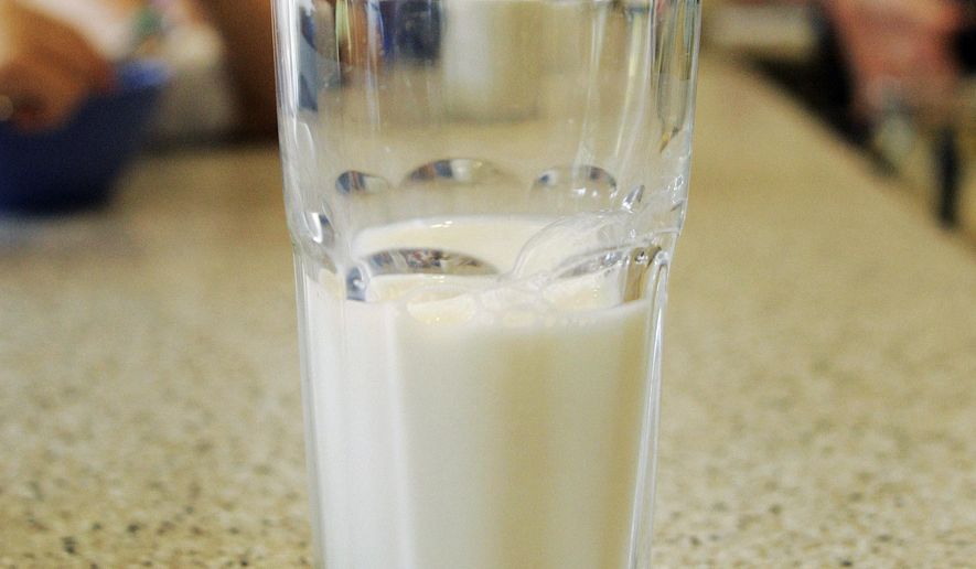 FILE - This June 8, 2007 file photo shows a glass of milk on a table during a family breakfast in Montgomery, Ala. Nearly 20 years ago, about nearly half of high school students said they drank at least one glass of milk a day. But now it’s down to less than a third, according to a survey released by the Centers for Disease Control and Prevention on Thursday, June 14, 2018. (AP Photo/Rob Carr)