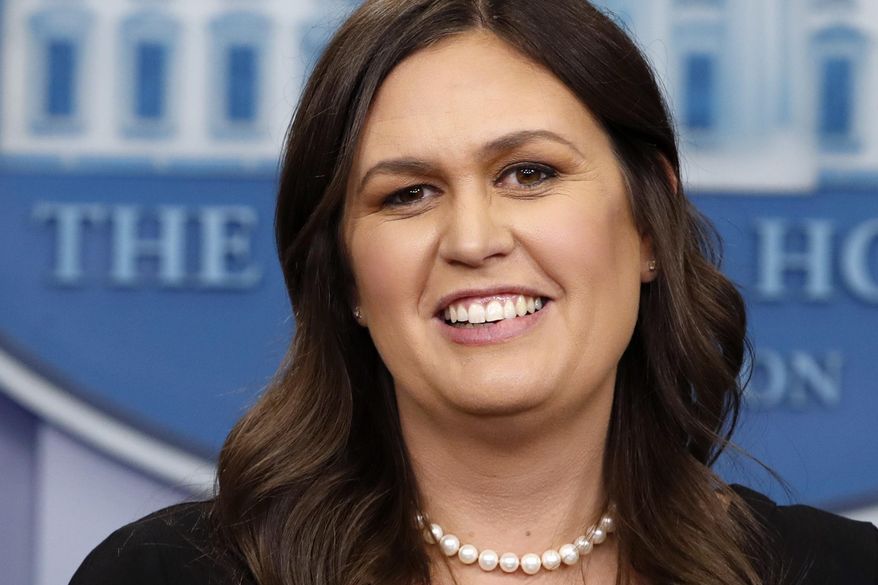 White House Press Secretary Sarah Huckabee Sanders smiles as she wishes President Donald Trump a happy birthday, during the daily briefing, Thursday, June 14, 2018, in the Briefing Room of the White House in Washington. (AP Photo/Jacquelyn Martin)