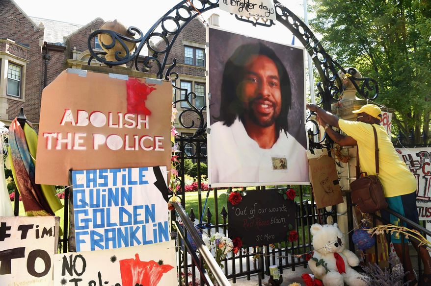 FILE - In this July 24, 2016, file photo, a photo of Philando Castile hangs on the gate of the governor's residence in St. Paul, Minn., as protesters demonstrate against the July 2016, shooting death of Castile by a St. Anthony police officer making a traffic stop in Falcon Heights, Mich. The St. Anthony Police Department announced new goals, Thursday, June 14, 2018, to help rebuild community trust following Castile's death. (Scott Takushi/Pioneer Press via AP)
