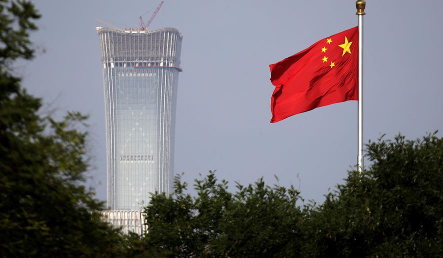 A Chinese national flag at Tiananmen Square flutters against the capital city tallest skyscraper China Zun Tower under construction at the Central Business District in Beijing Thursday, June 14, 2018. U.S. President Donald Trump approved a plan to impose punishing tariffs on tens of billions of dollars of Chinese goods as early as Friday, a move that could put his trade policies on a collision course with his push to rid the Korean Peninsula of nuclear weapons. (AP Photo/Andy Wong)