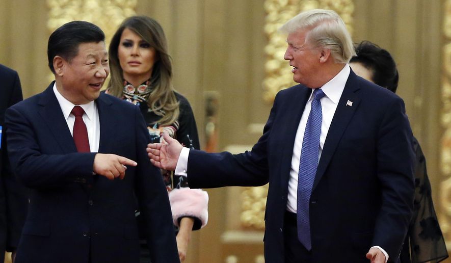 In this Nov. 9, 2017, file photo, U.S. President Donald Trump China&#39;s President Xi Jinping arrive for the state dinner with the first ladies at the Great Hall of the People in Beijing, China. (Thomas Peter/Pool Photo via AP, File)