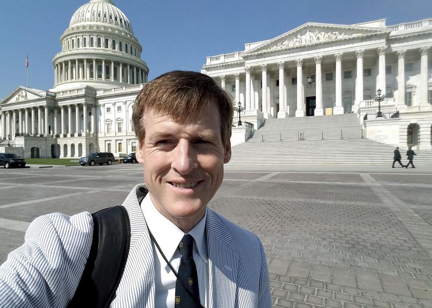 In this Aug. 2, 2017 photo released by Jamie Dupree, Dupree, a Cox Media Group radio reporter, poses in front of the U.S. Capitol in Washington. Two years ago, Dupree encountered what others in his profession might see as an unsurmountable challenge: He lost his voice. Now he may have found a solution. A Scottish company that creates text-to-speech technology has crafted a new "voice" for Dupree: software turns his typed sentences into spoken words. (Jamie Dupree via AP)