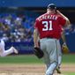 Toronto Blue Jays&#39; Devon Travi, left, rounds the bases after hitting a two-run home run against the Washington Nationals starting pitcher Max Scherzer (31) during the fifth inning inning of a baseball game in Toronto on Saturday, June 16, 2018. (Frank Gunn/The Canadian Press via AP) **FILE**