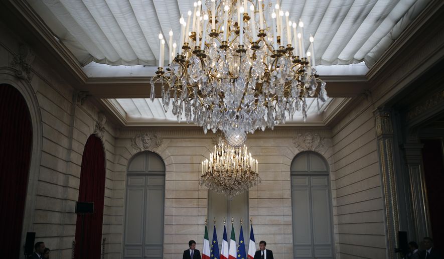 French president Emmanuel Macron, right, and Italian Premier Giuseppe Conte attend a joint press conference during their meeting at the Elysee Palace in Paris, France, Friday, June 15, 2018. French President Emmanuel Macron and new Italian Premier Giuseppe Conte meet Friday amid tensions between the two countries over migration. (AP Photo/Francois Mori, pool)