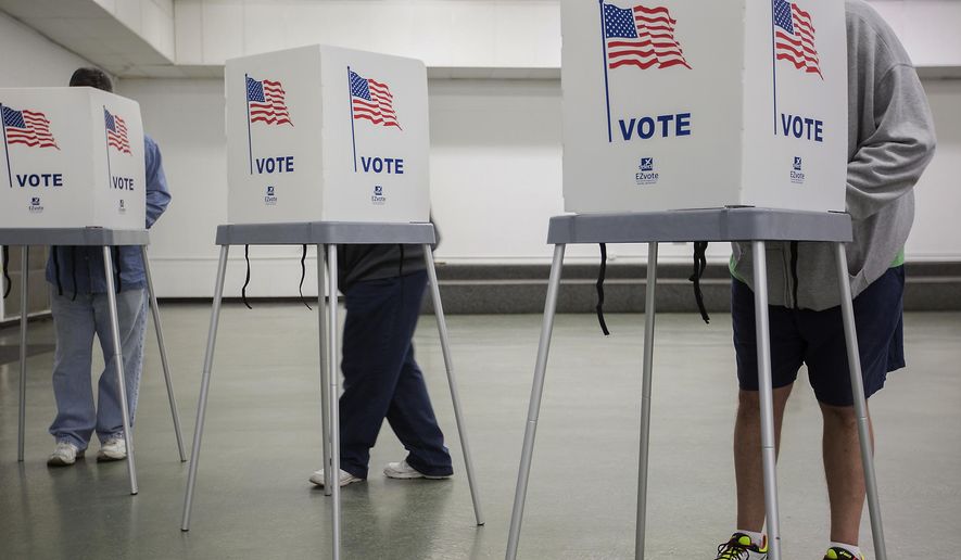 FILE - In a Nov. 8, 2016 file photo, McCracken County residents vote at the Robert Cherry Civic Center in Paducah, Ky. Kentucky residents will head to the polls Tuesday, May 15, 2018, in a midterm primary election with nominations up for grabs in the U.S. House and the Legislature. (Ryan Hermens/The Paducah Sun via AP, File)