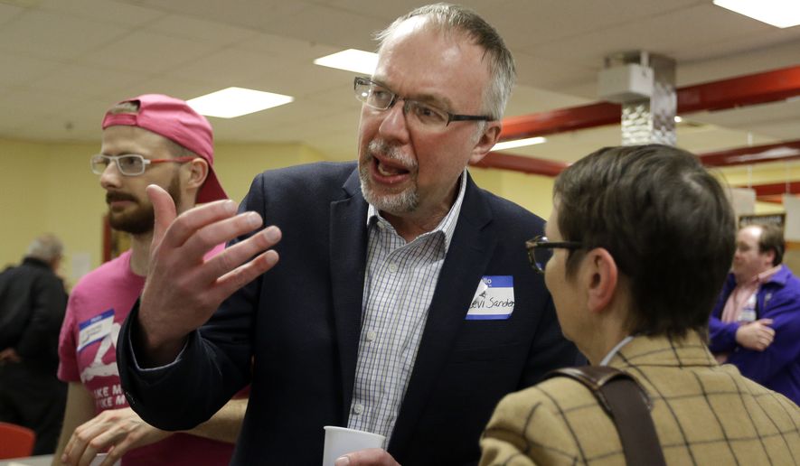 Levi Sanders, candidate for U.S. Congress, speaks with a potential voter at a candidates&#x27; forum, Thursday, April 5, 2018, in Rochester, N.H. Voters are getting their first chance to hear from the son of Bernie Sanders, who is making a run for Congress in New Hampshire. (AP Photo/Elise Amendola)